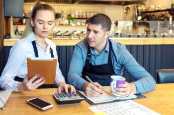 Two employees working in a cafe