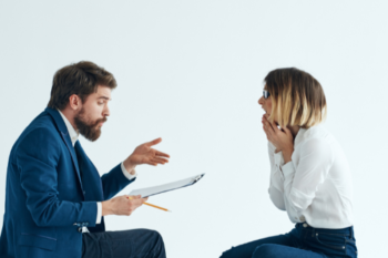 Two people talking with clipboards