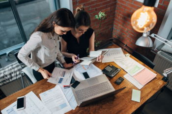 Two Young Women Working on Bookkeeping and Accounting