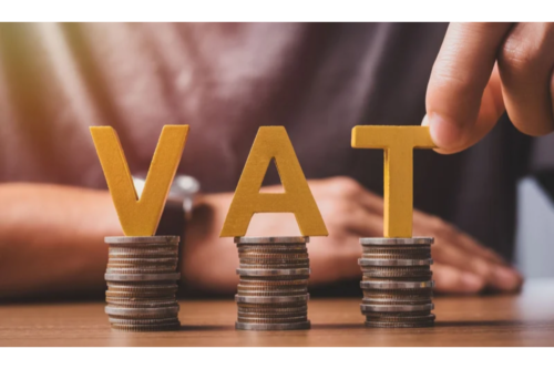 Stacked coins with VAT letters on top.