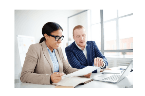 Two people working on annual accounts